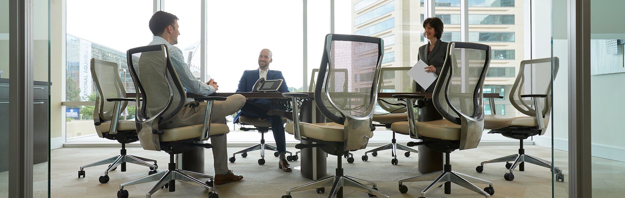 Conference room with people sitting in chairs