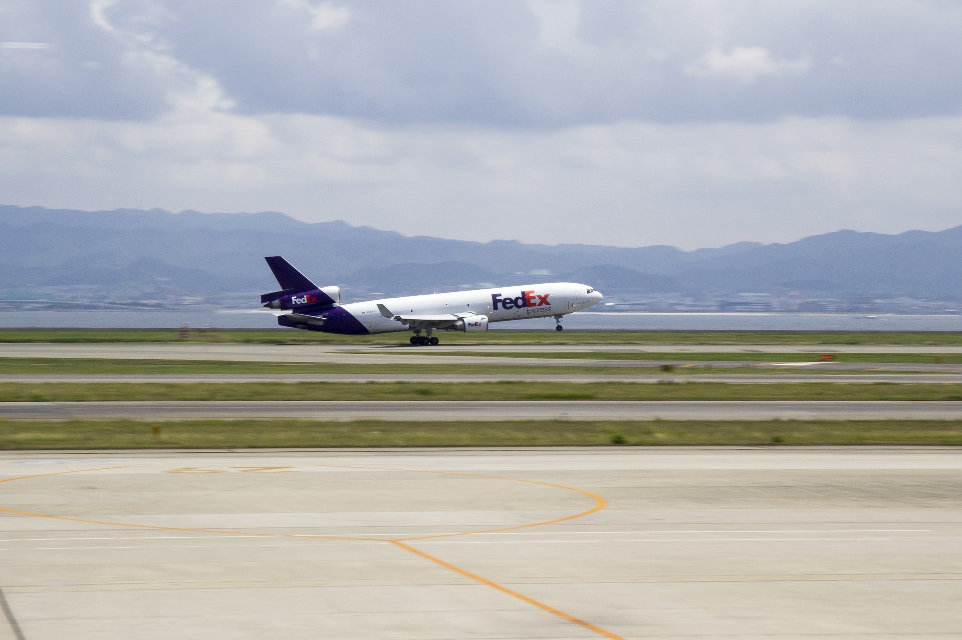 FedEx plan taking off on runway.