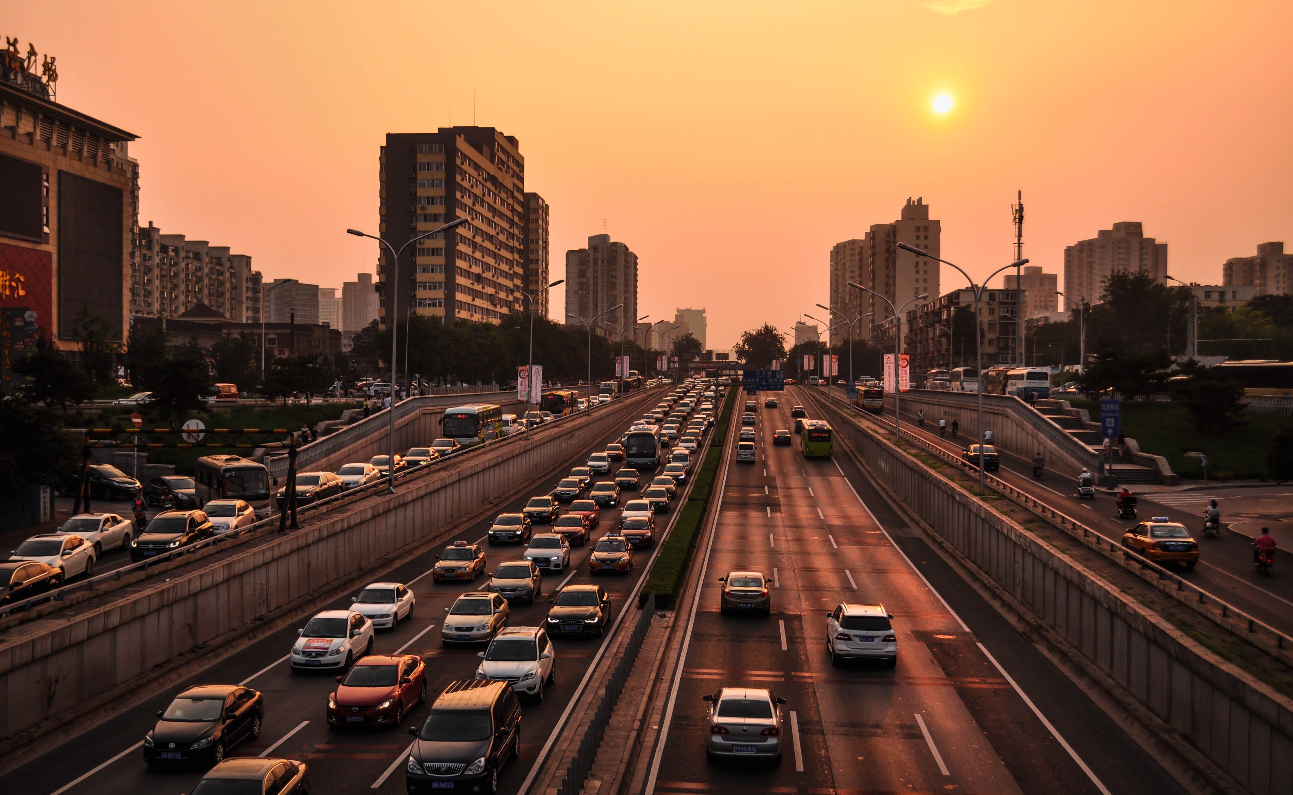 Roads leading in and out of a city during sunset.