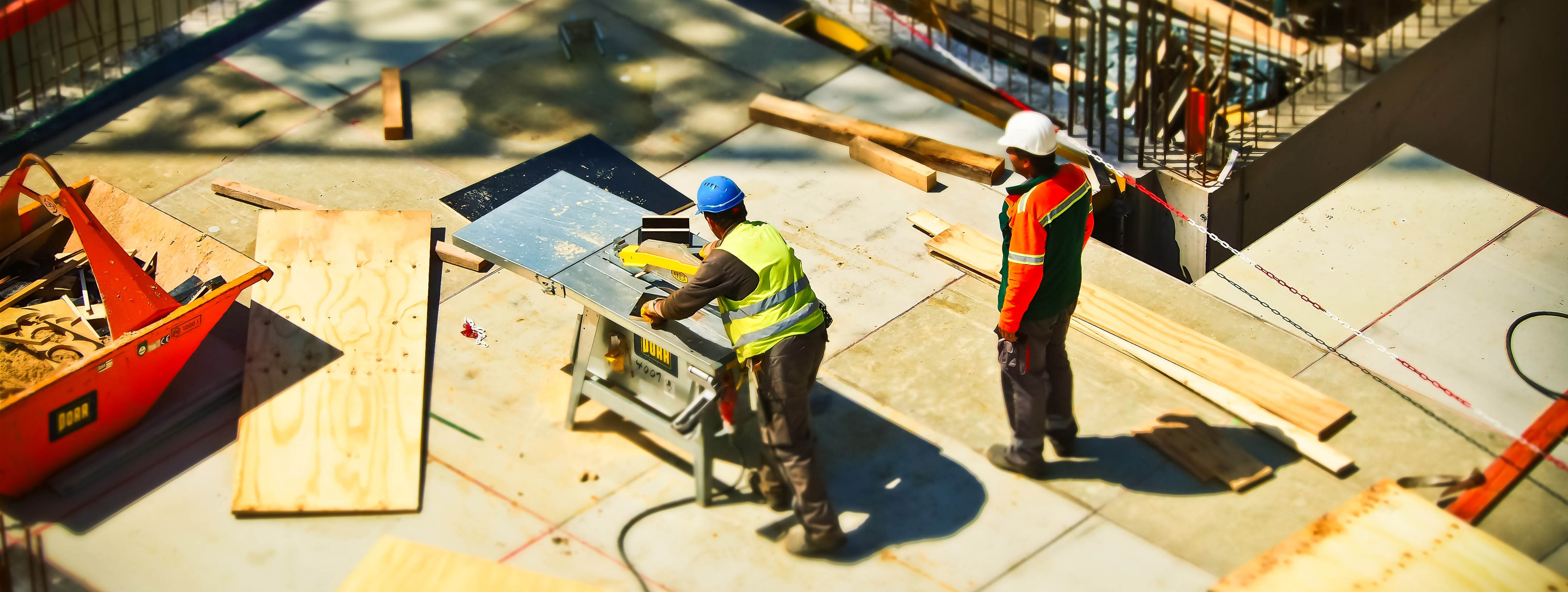 Aerial view of two men working on a construction site.