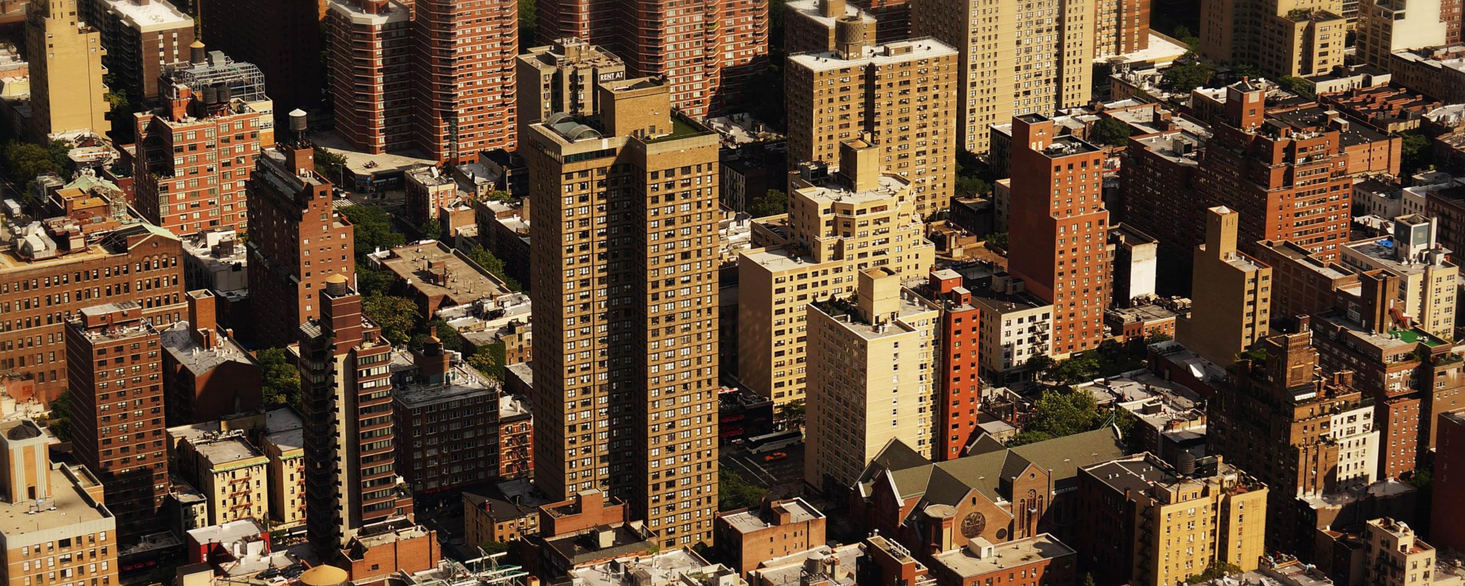 Aerial view of unidentifiable brick and concrete buildings.