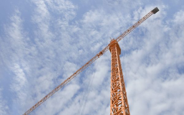 Orange scaffold against blue cloudy sky.