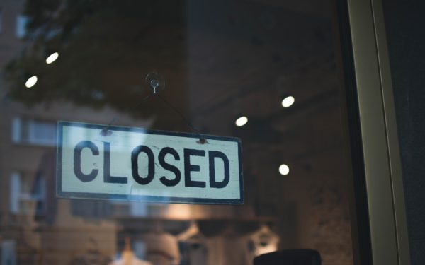 Closed sign on glass shop door.