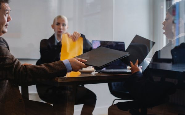 Three people in a business meeting.