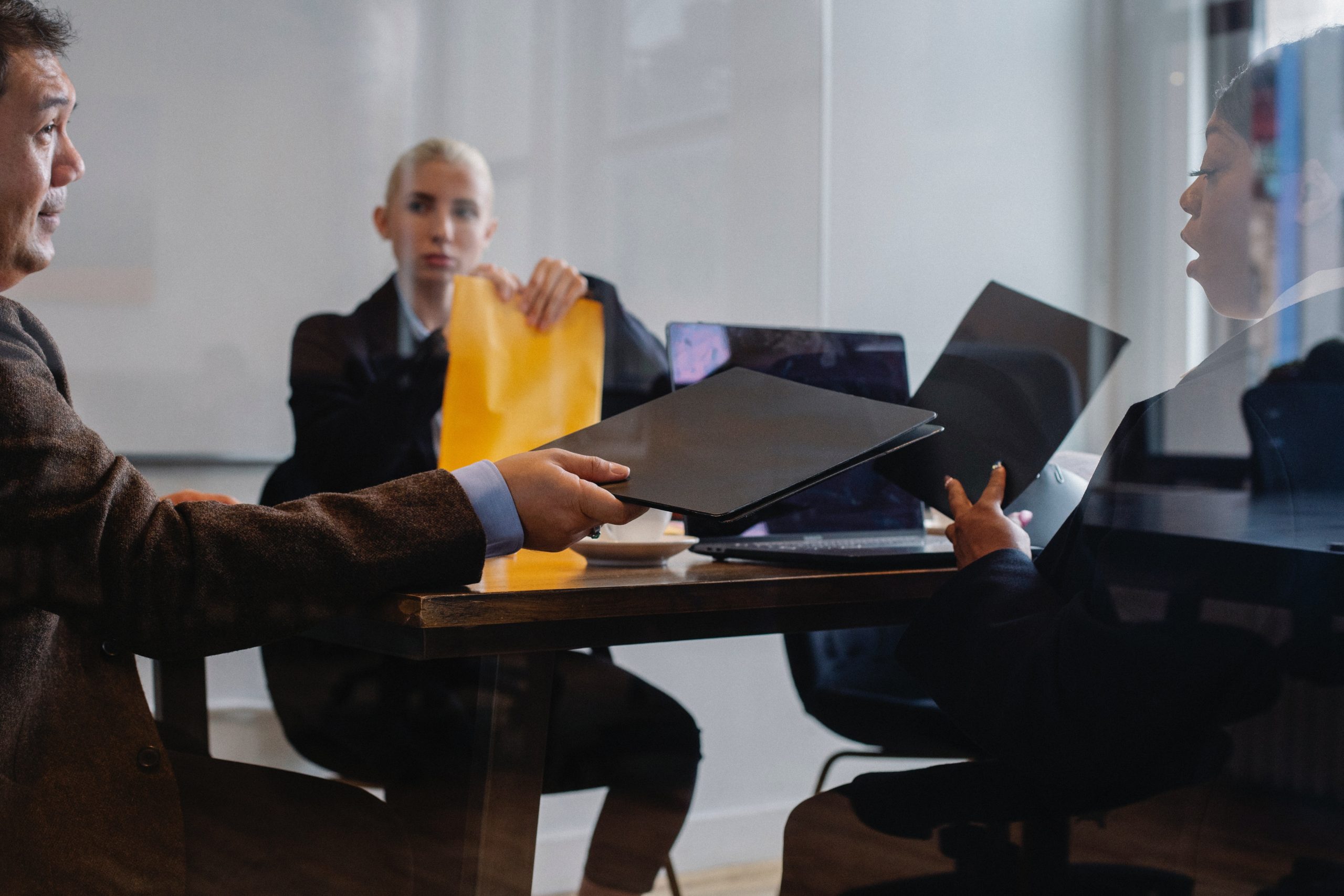 Three people in a business meeting.