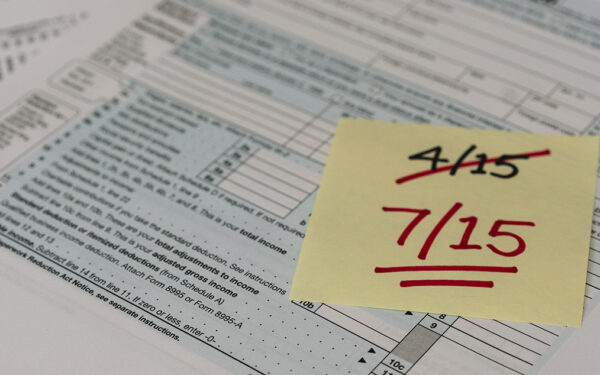 post-it-note-with-4/15-crossed-out-7/15-written-underneath