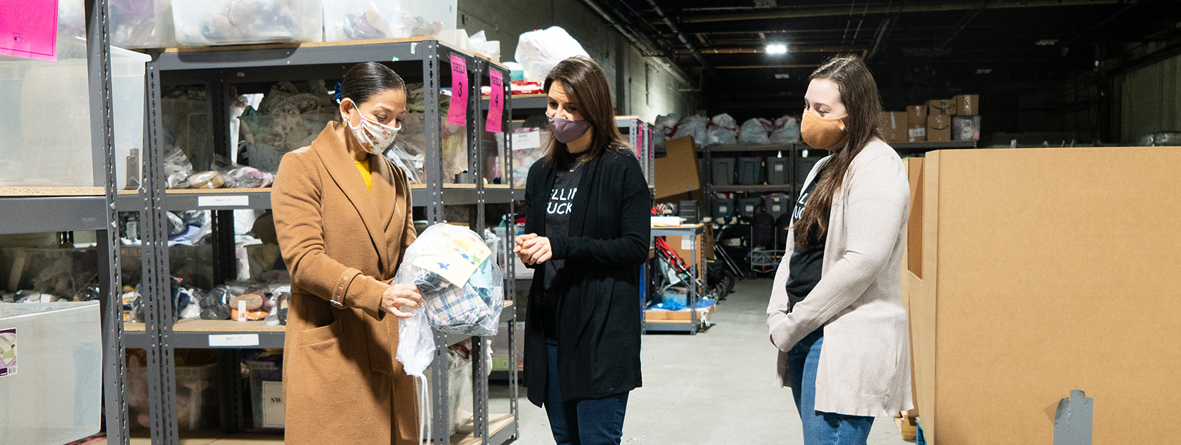 Executive director of Sharebaby gives Ellin & Tucker employees tour of warehouse.