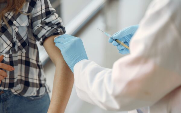 Doctor giving patient vaccination in arm