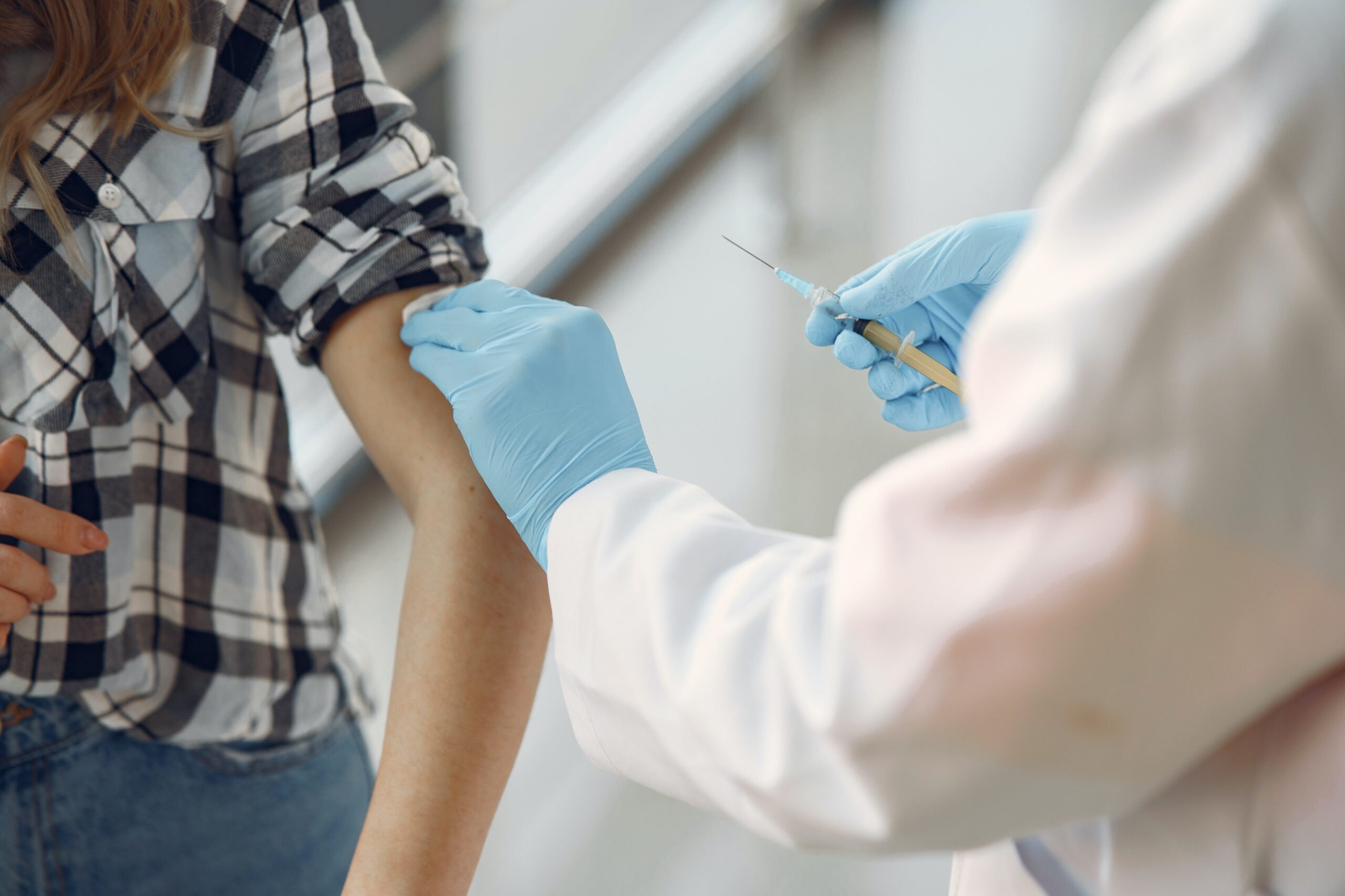 Doctor giving patient vaccination in arm