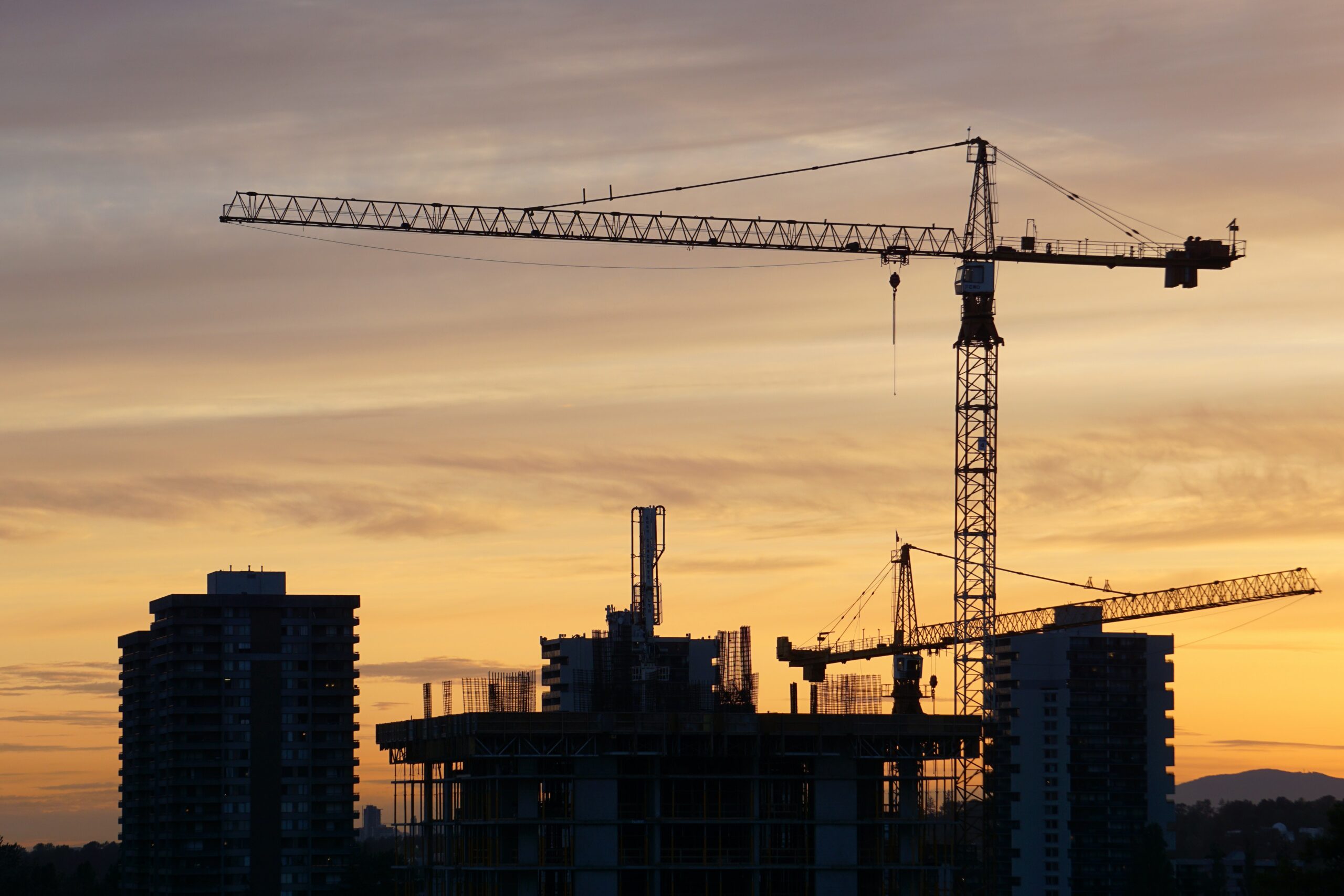 Silhouette of construction site at sunset.