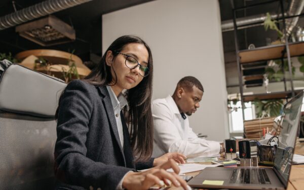 Man and woman working at desks on computers.