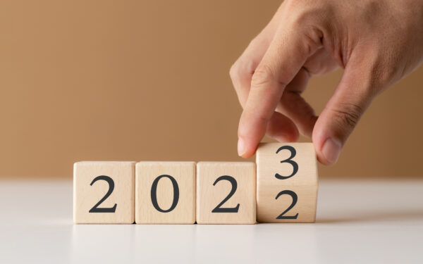 Wooden cubes that spell out 2023 on white table.