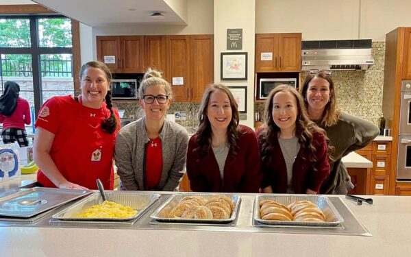 Ronald McDonalg House Charities of Maryland's Red Shoe Crew poses while serving breakfast to residents