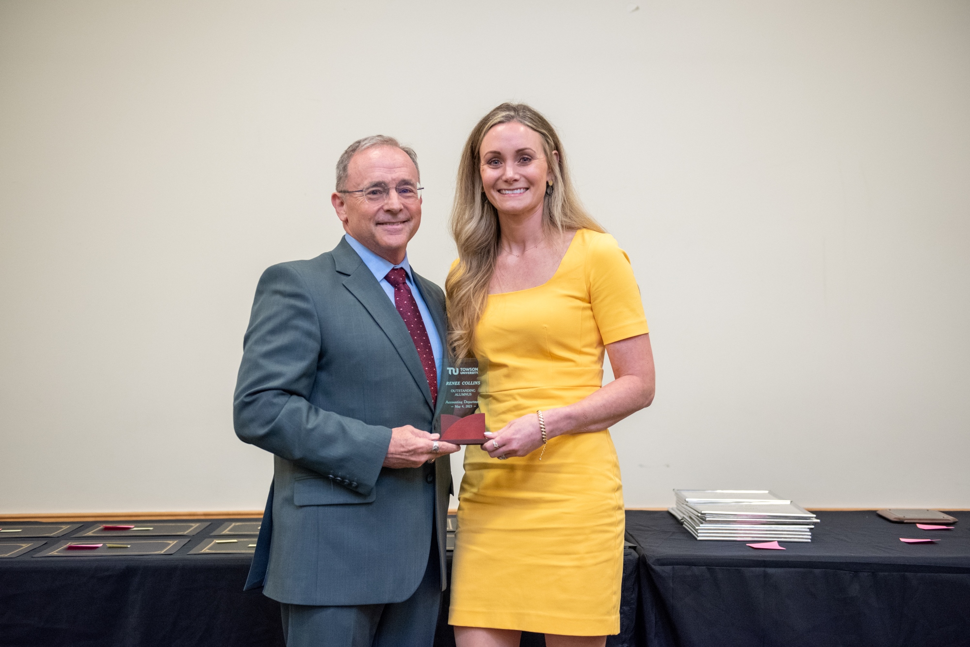 Renee Collins holding Towson University Accounting Department's Outstanding Alumnus award.