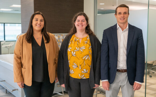 Jen Gavin Colleen McNulty and Ben Bloom stand together in Ellin & Tucker's office.