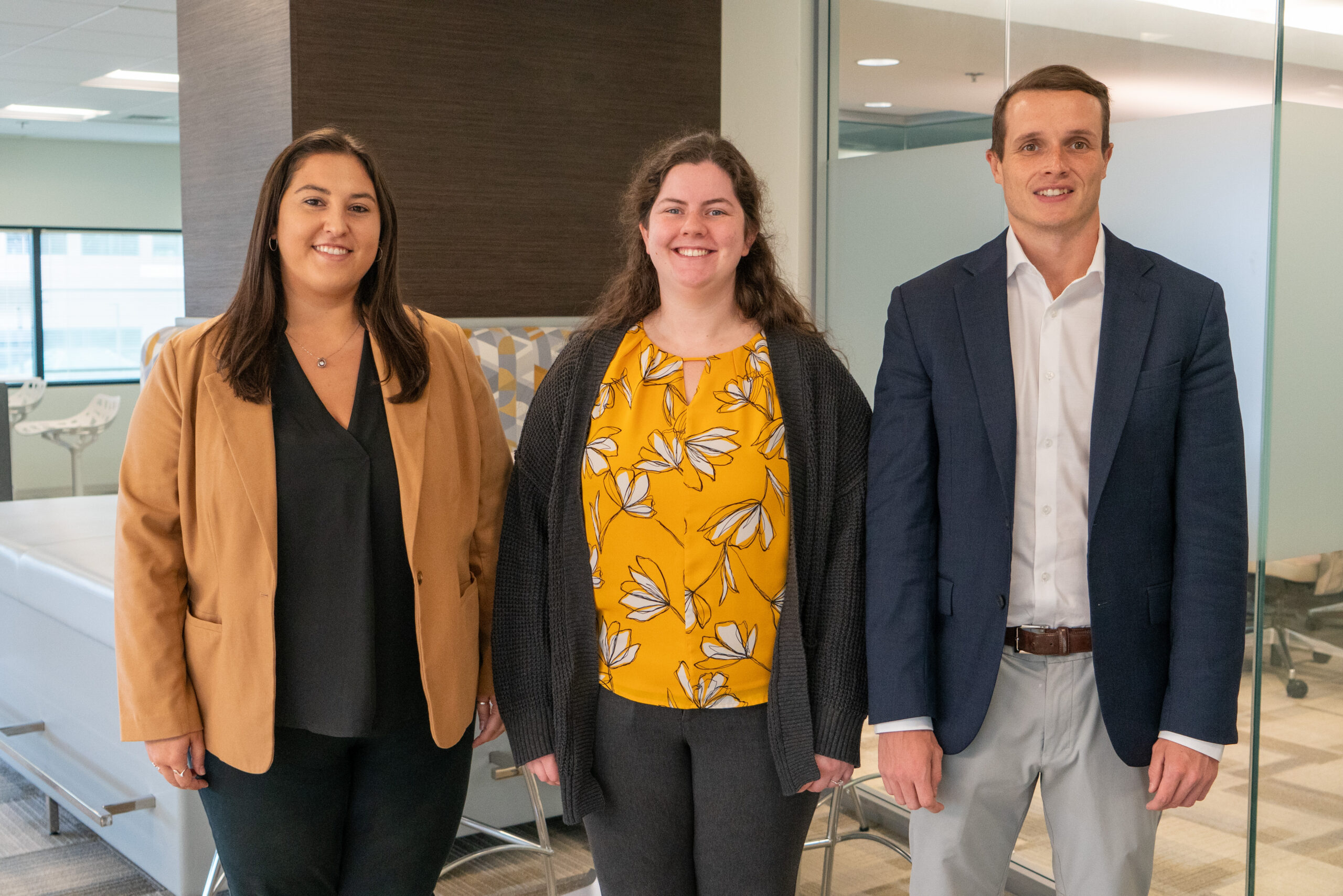 Jen Gavin Colleen McNulty and Ben Bloom stand together in Ellin & Tucker's office.