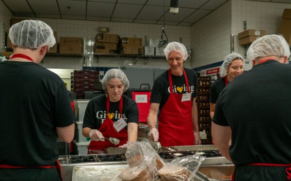 Mia Applegate and David Schriver packaging meals at Meals on Wheels of Central Maryland
