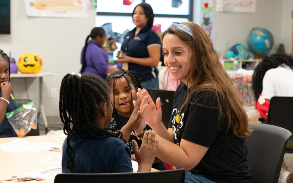 Lisa Bish audit and accounting supervisor plays with students at Living Classrooms after school program.