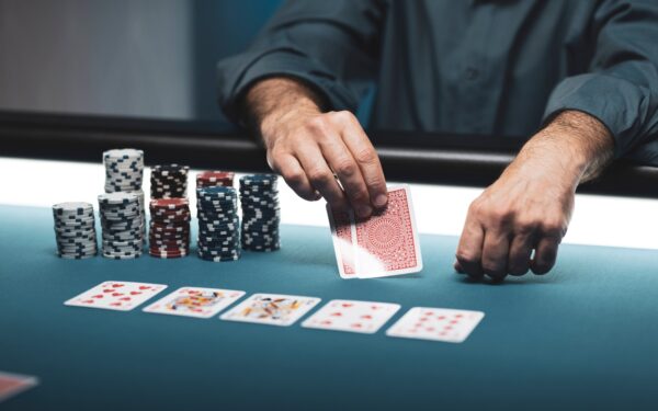 man playing card game at table