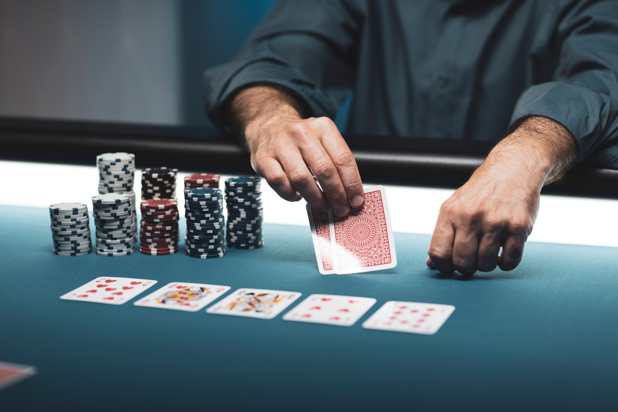 man playing card game at table