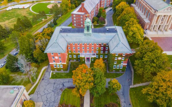 Aerial shot of private school campus with brick buildings among fall foliage