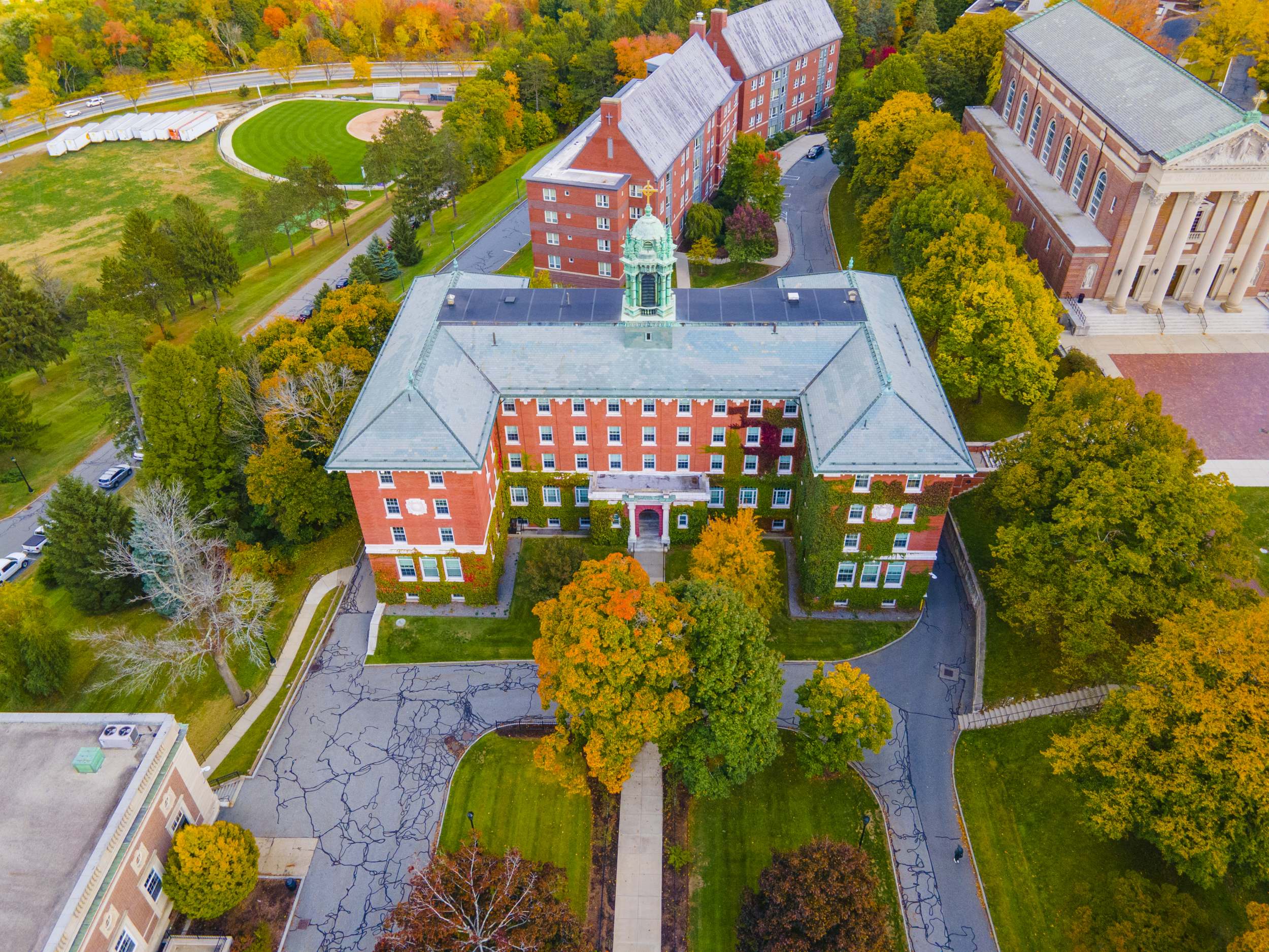 Aerial shot of private school campus with brick buildings among fall foliage